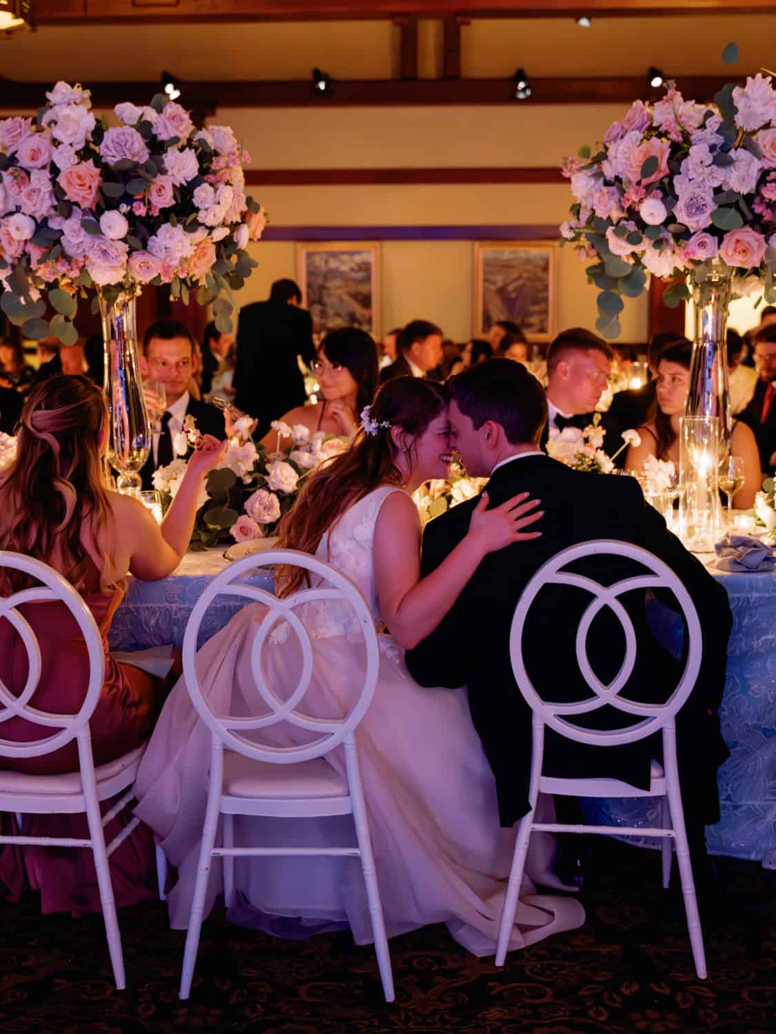 Elegant wedding reception with floral centerpieces and romantic ambiance.