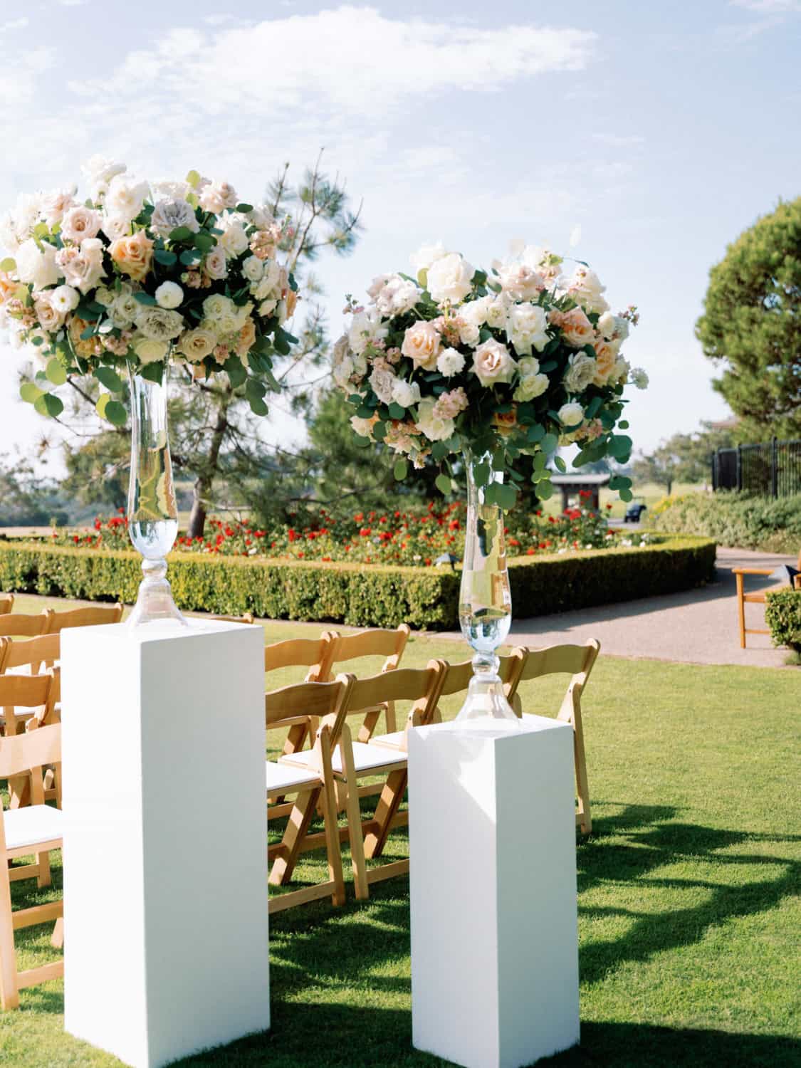 Beautiful floral centerpieces with white and blush roses for outdoor events.