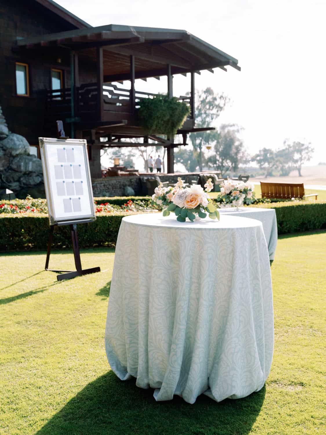 Outdoor event table with floral arrangement at a luxurious venue.