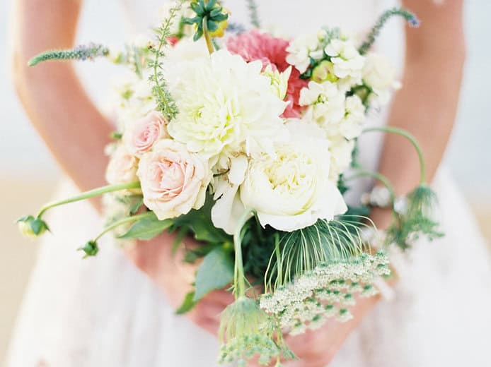Beautiful wedding bouquet featuring roses, peonies, and greenery for a sophisticated soirée celebrat.