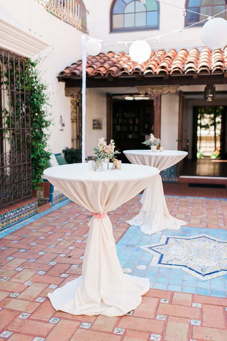 High-top tables with floral arrangements for outdoor event at Type A Soiree.