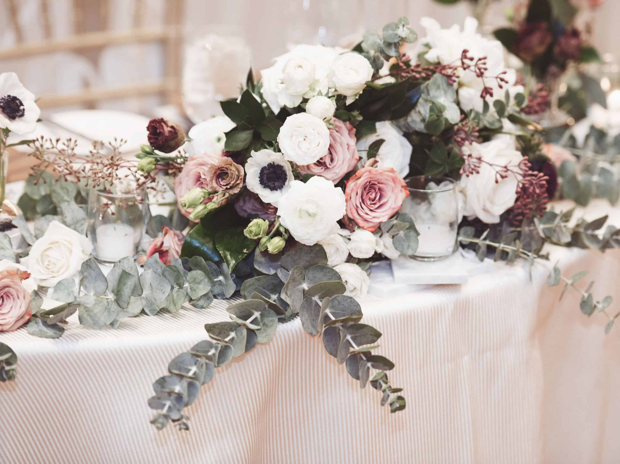 Beautiful floral arrangement featuring roses and eucalyptus for a stylish event decor.