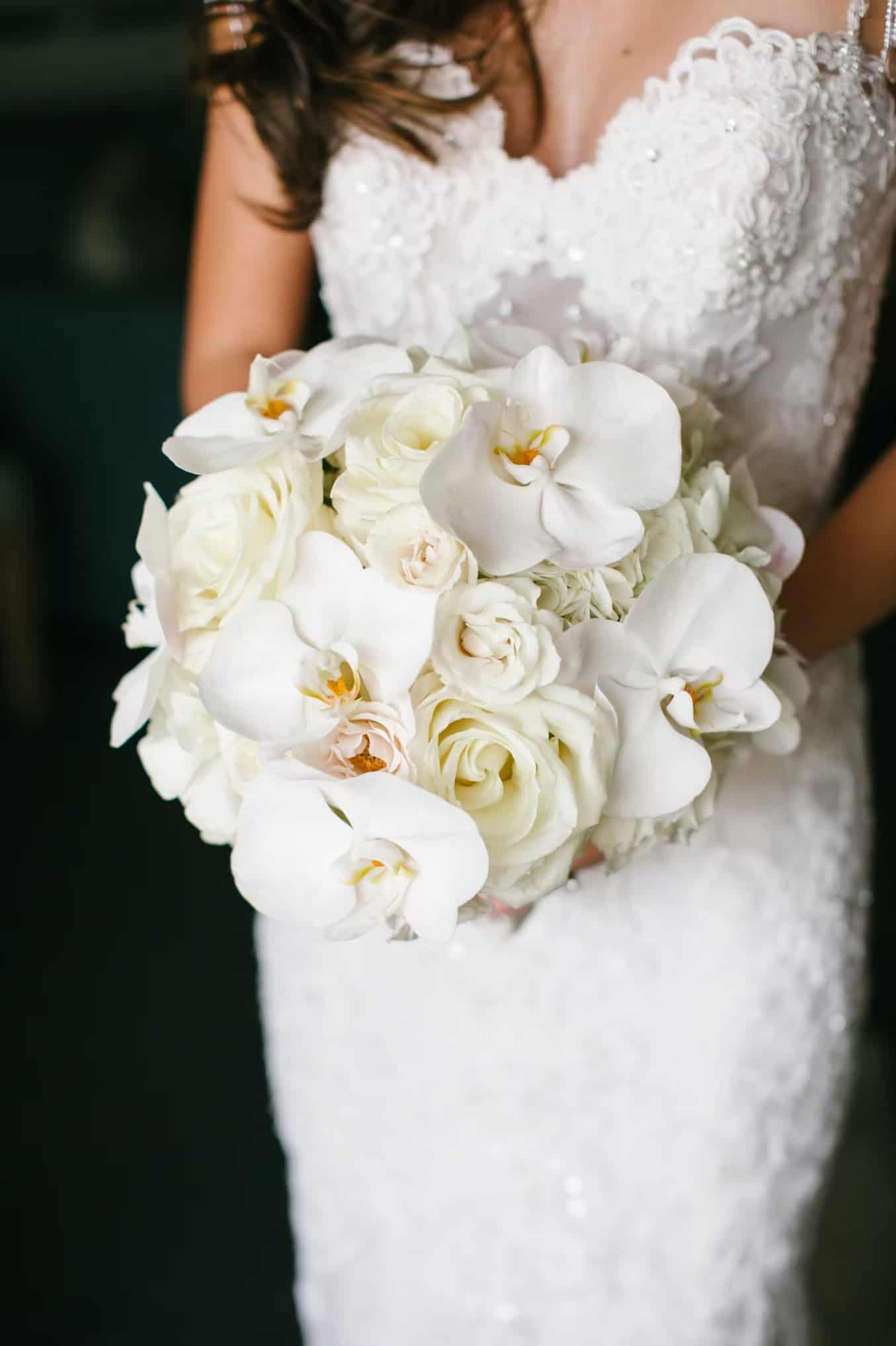 Elegant white wedding bouquet featuring orchids and roses for bridal accessories.